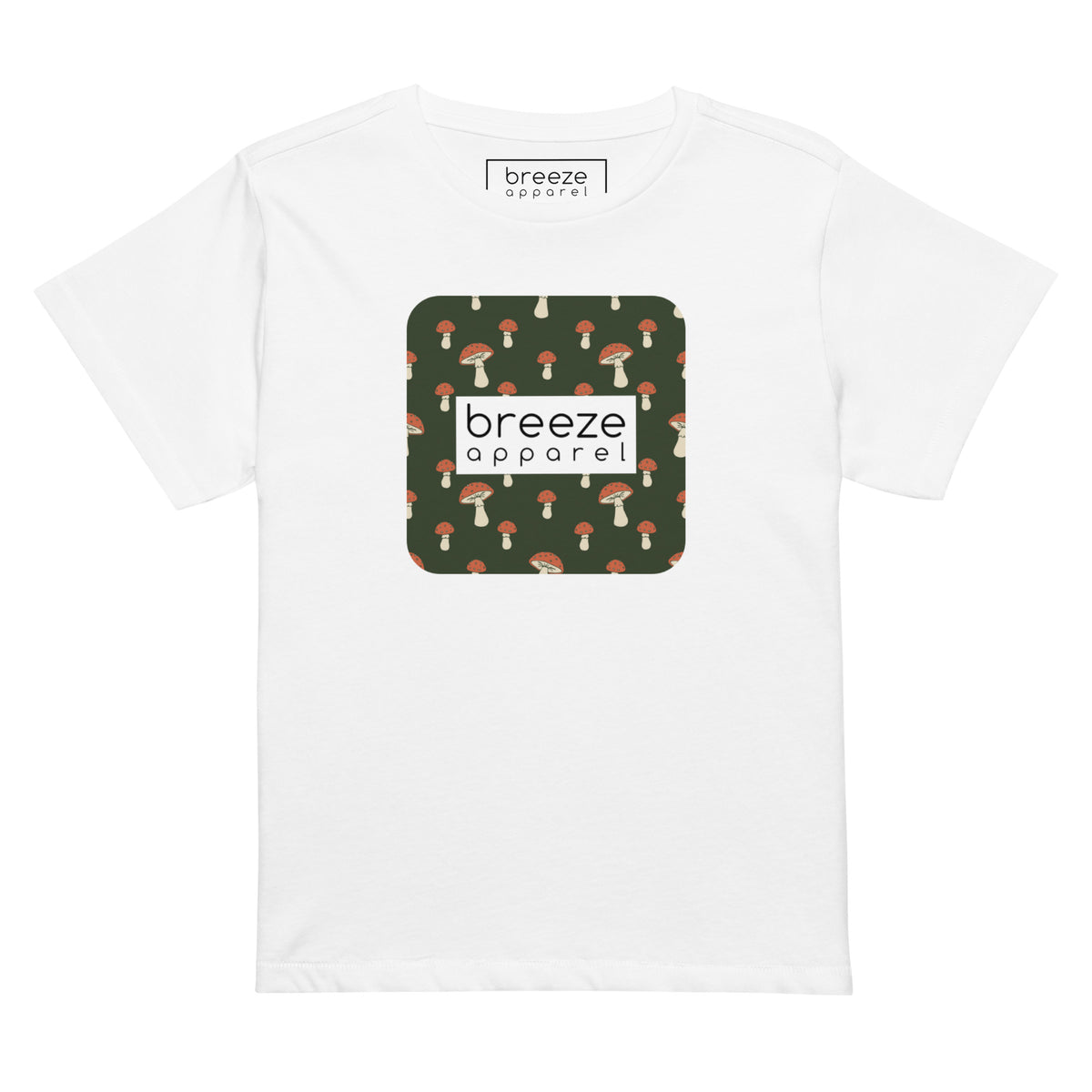 White t-shirt with design of mushrooms set on green background and overlaid with a white rectangle with 'breeze apparel' in black inside.