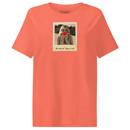 Orange t-shirt with graphic of woman holding a watermelon slice in front of her mouth.