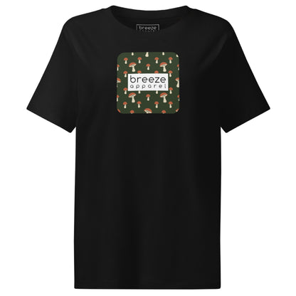Black t-shirt with square graphic of mushrooms set on a green background overlaid with a white rectangle in which 'breeze apparel' is in black.
