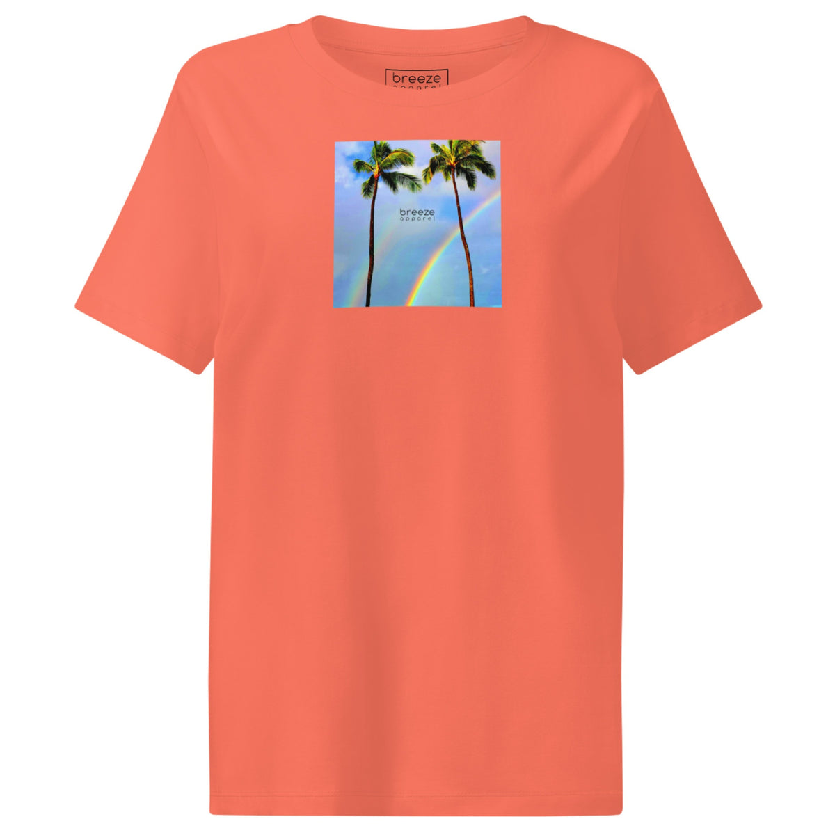 Fiesta-orange t-shirt with a graphic of palm trees, rainbow, and a clear blue sky in the background. A small, black 'breeze apparel' logo is between the trees.