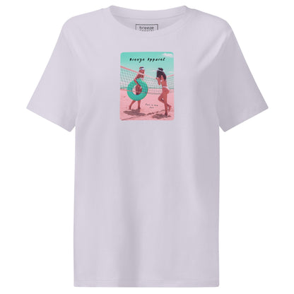 Lavender t-shirt with an image of two women in bikinis on the beach, standing by a volleyball net, one holding a swim ring and smiling, the other leaning on the net, with inscription in black of 'breeze apparel' towards the top of the image, and 'fun in the sun' in black on the ground between the women. 