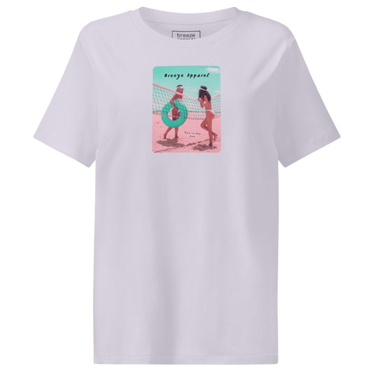 Lavender t-shirt with an image of two women in bikinis on the beach, standing by a volleyball net, one holding a swim ring and smiling, the other leaning on the net, with inscription in black of 'breeze apparel' towards the top of the image, and 'fun in the sun' in black on the ground between the women. 
