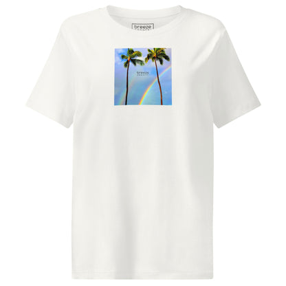 Off-white t-shirt with a graphic of palm trees, rainbow, and a clear blue sky in the background. A small, black 'breeze apparel' logo is between the trees.