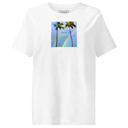 White t-shirt with a graphic of palm trees, rainbow, and a clear blue sky in the background. A small, black 'breeze apparel' logo is between the trees.