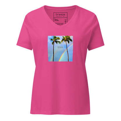 Berry-pink v-neck t-shirt with a graphic of palm trees, rainbow, and a clear blue sky in the background. A small, black 'breeze apparel' logo is between the trees. 