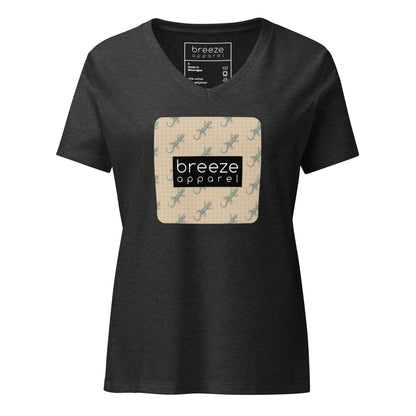 Gray t-shirt with square over chest that contains pattern of green geckos set on beige background, overlaid with black, rectangular logo with white lettering.