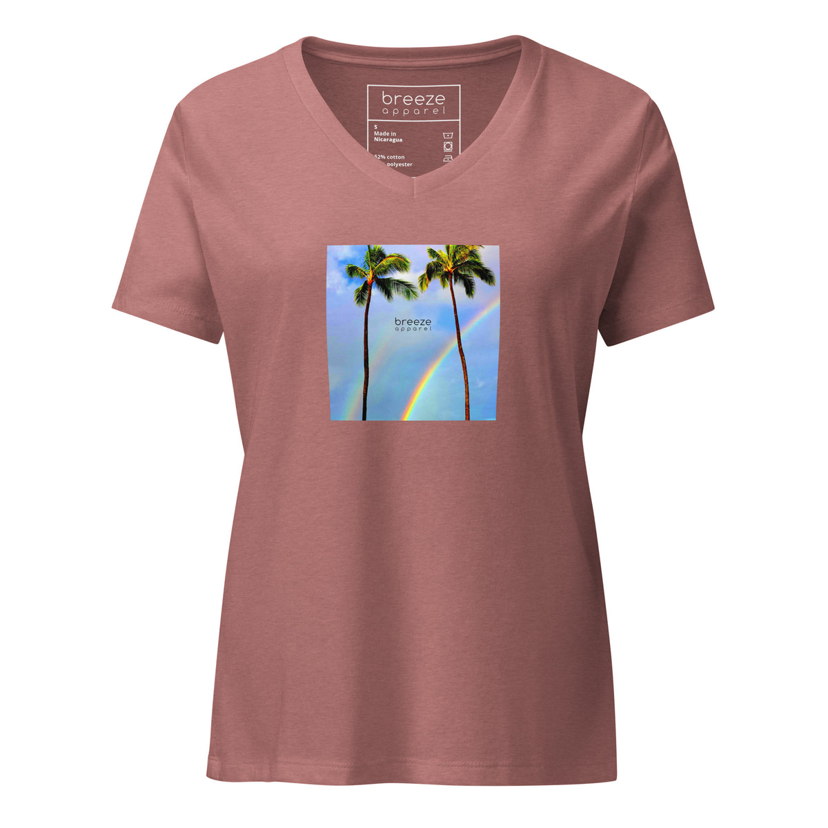 Heather-mauve v-neck t-shirt with a graphic of palm trees, rainbow, and a clear blue sky in the background. A small, black 'breeze apparel' logo is between the trees. 
