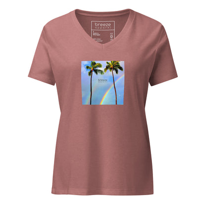 Heather-mauve v-neck t-shirt with a graphic of palm trees, rainbow, and a clear blue sky in the background. A small, black 'breeze apparel' logo is between the trees. 