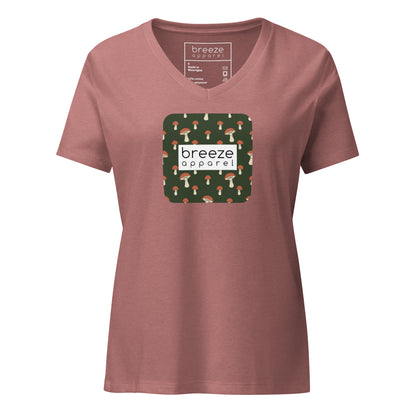 Mauve v-neck t-shirt with graphic of mushrooms set on a green background and overlaid with white logo.