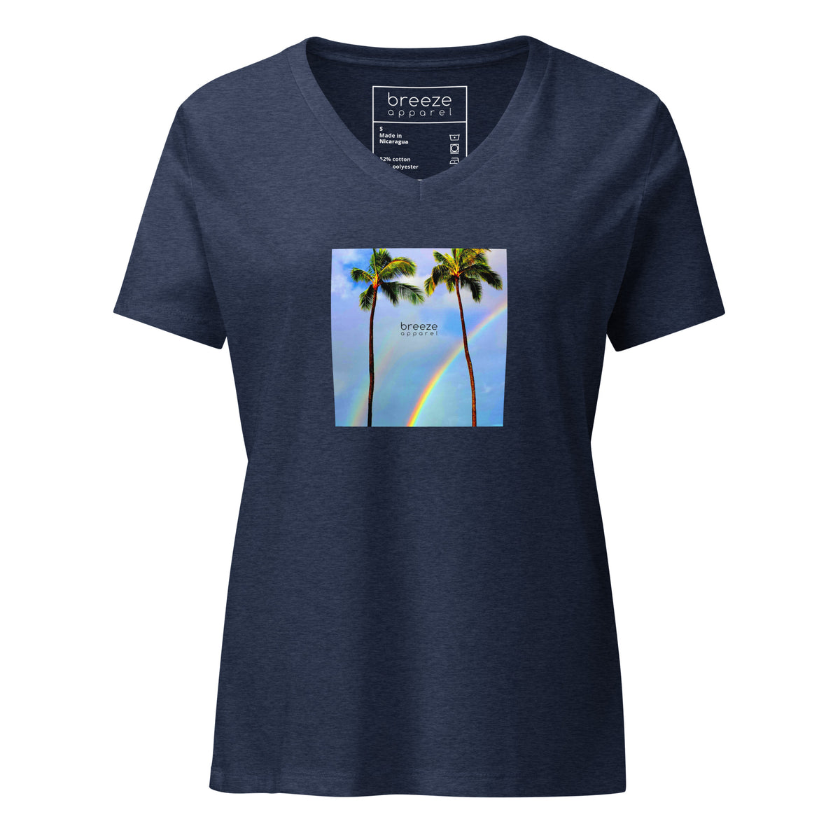 Heather-navy v-neck t-shirt with a graphic of palm trees, rainbow, and a clear blue sky in the background. A small, black 'breeze apparel' logo is between the trees. 