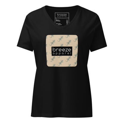 Black t-shirt with square over chest that contains pattern of green geckos set on beige background, overlaid with black, rectangular logo with white lettering.