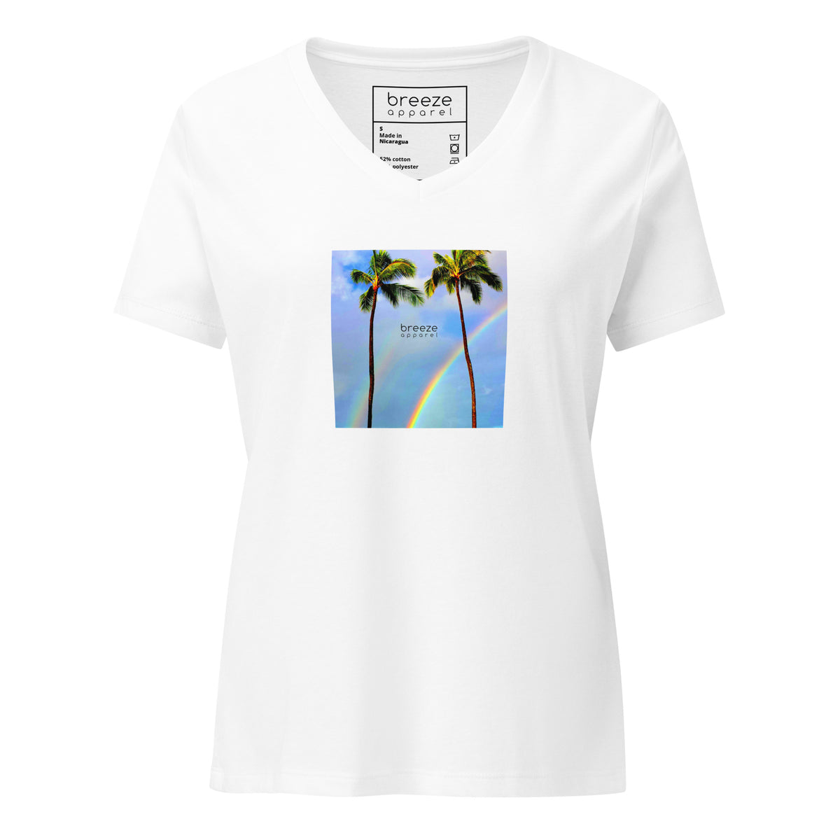 White v-neck t-shirt with a graphic of palm trees, rainbow, and a clear blue sky in the background. A small, black 'breeze apparel' logo is between the trees. 