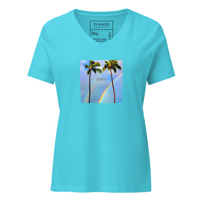 Turquoise v-neck t-shirt with a graphic of palm trees, rainbow, and a clear blue sky in the background. A small, black 'breeze apparel' logo is between the trees. 